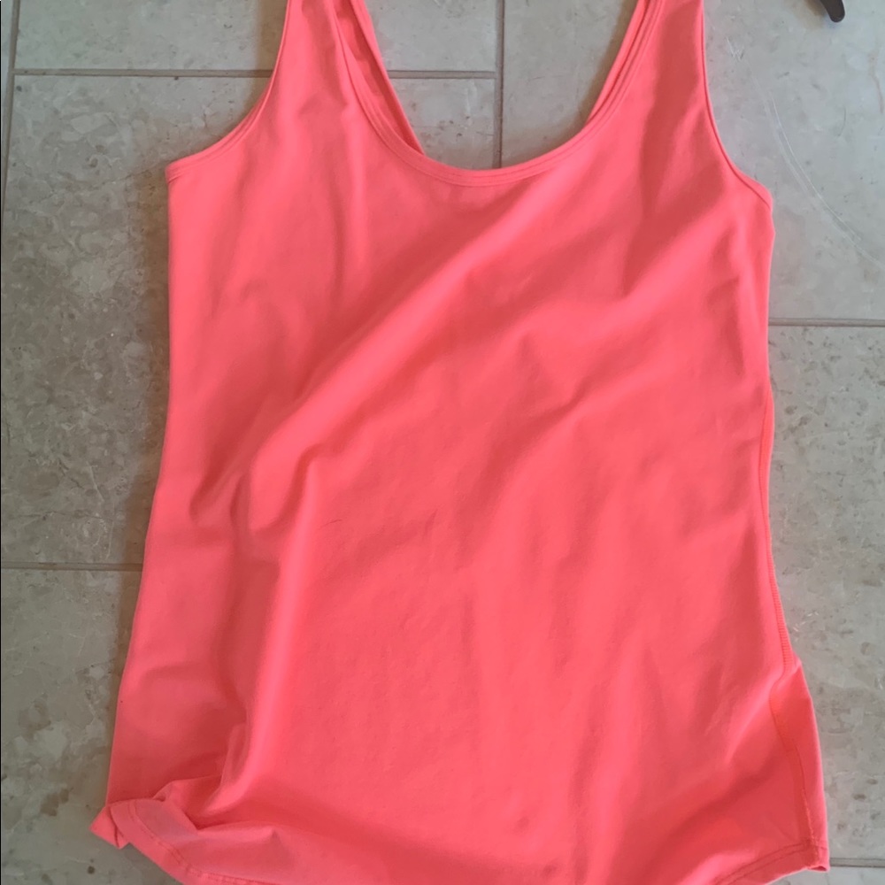 Hardly worn size 6 lululemon top. Neon orange.